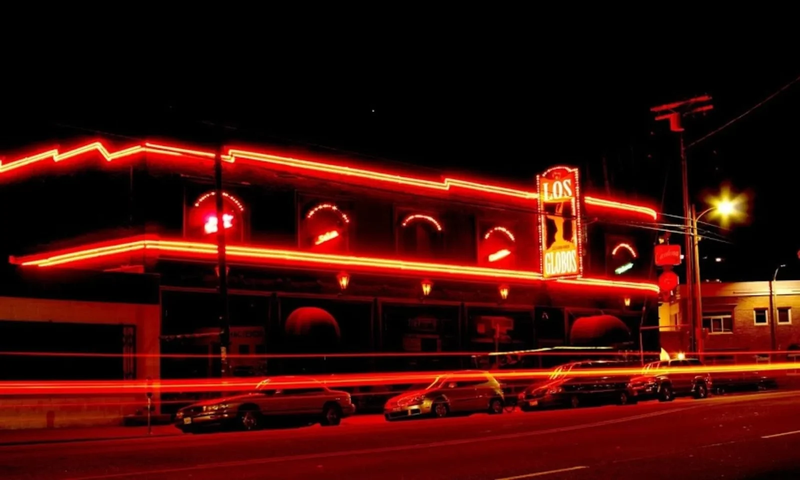 The red-lit exterior of Los Globos on Sunset Boulevard