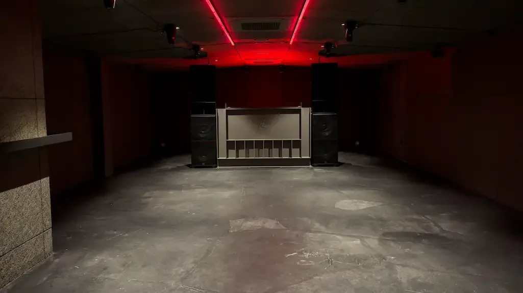 The DJ booth and red ceiling lights at Volnost in Seoul