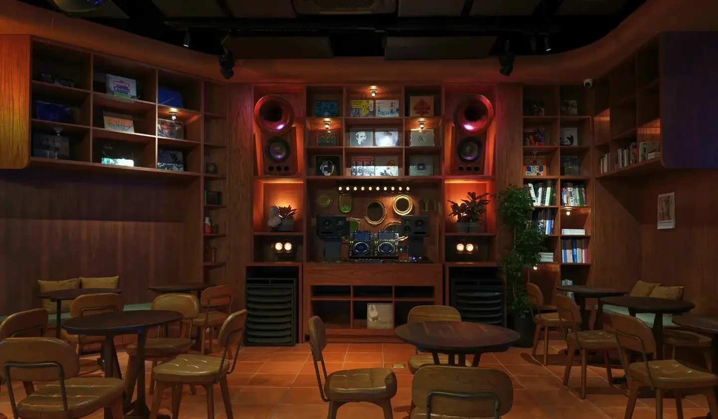 The timber DJ booth, shelves and sound system at Wigwam in Shanghai