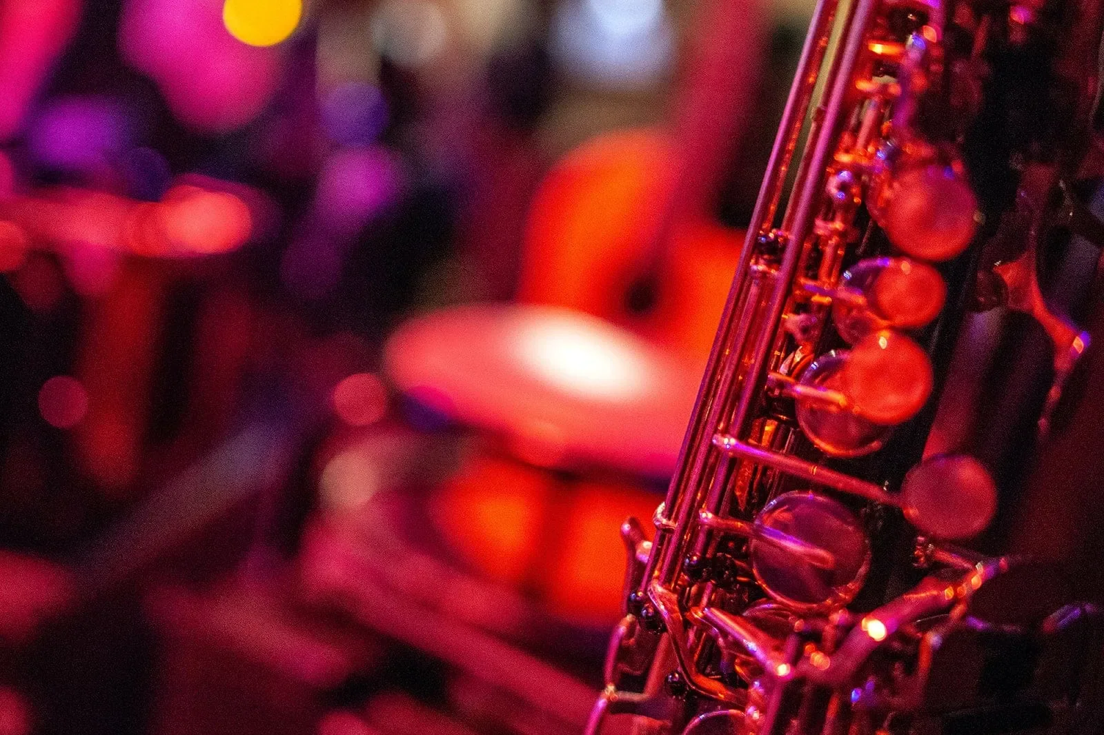 A saxophone under coloured stage lights, the photograph featured on Boogie Woogie’s official website