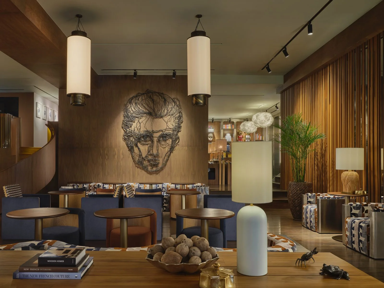 A warmly lit lounge with timber screens and pendant lamps at Public House Bangkok