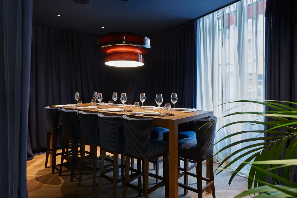 A private dining table beneath a sculptural light at Amar Barcelona