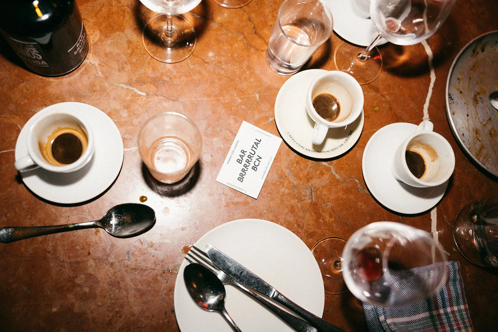 Coffee cups and wine glasses on a cafe table at Bar Brutal