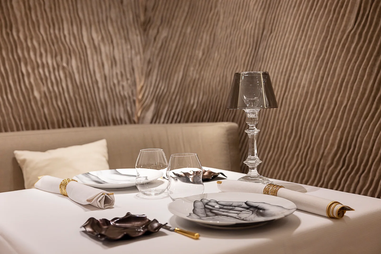 A table set against textured gold-toned walls at Caelis