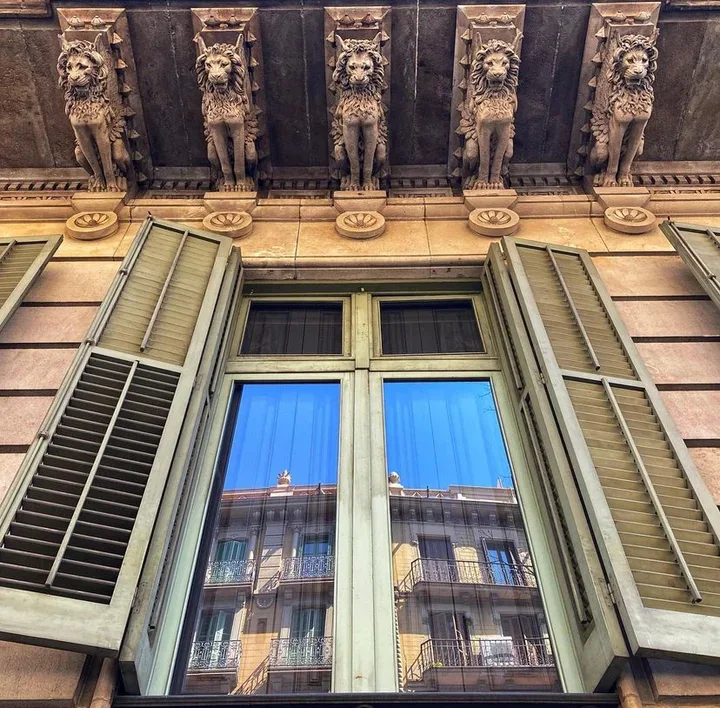 La Casa Elizalde: ornamental woodwork above a tall window in the historic facade