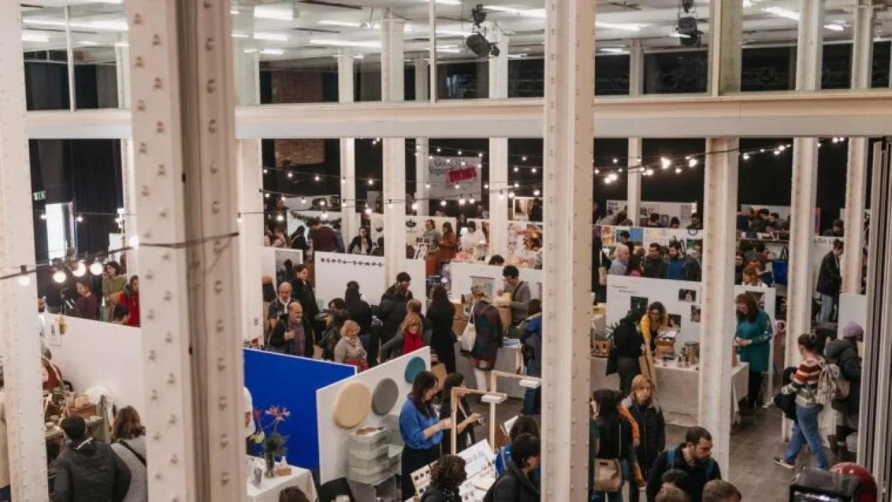 Visitors browsing a market inside the former factory hall at Fabra i Coats, Fàbrica de Creació