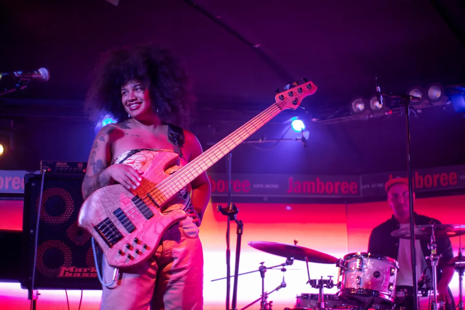 Jamboree: a bassist performing on a purple-lit stage, shown on its official website