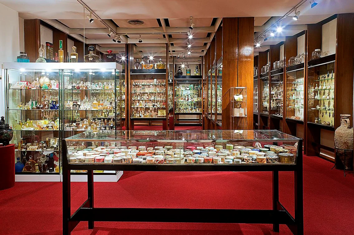 Glass display cases filled with perfume bottles at Museu del Perfum