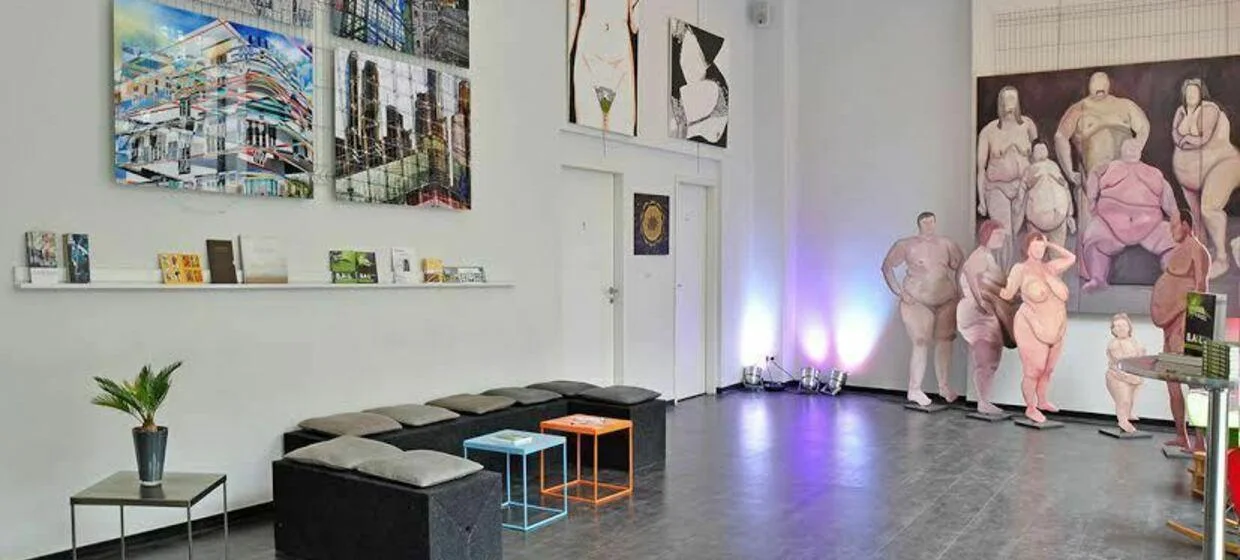 Art Stalker: artworks and lounge seating arranged through the open gallery-bar