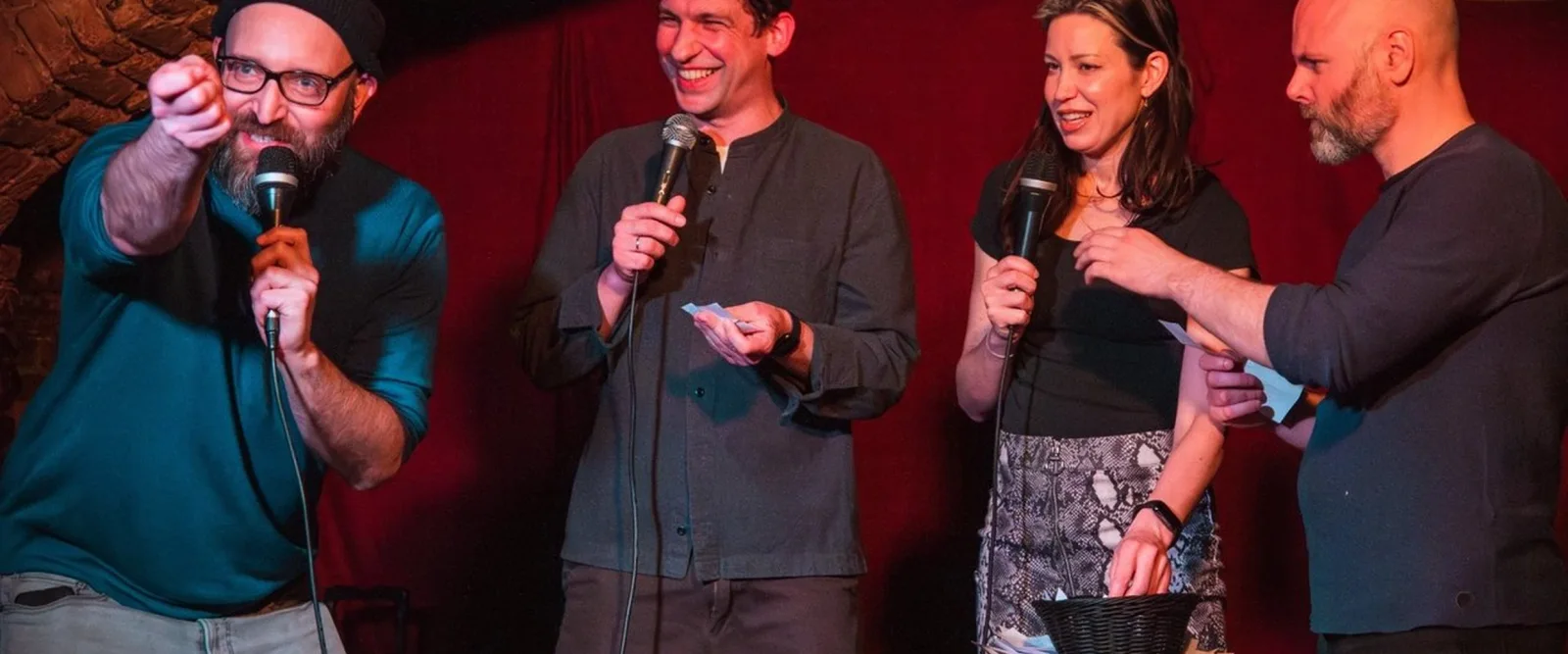 Comedians holding microphones during a club showcase at Epic Comedy Club Berlin