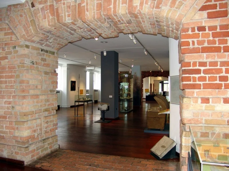Gotisches Haus: a brick-vaulted passage opening onto museum displays