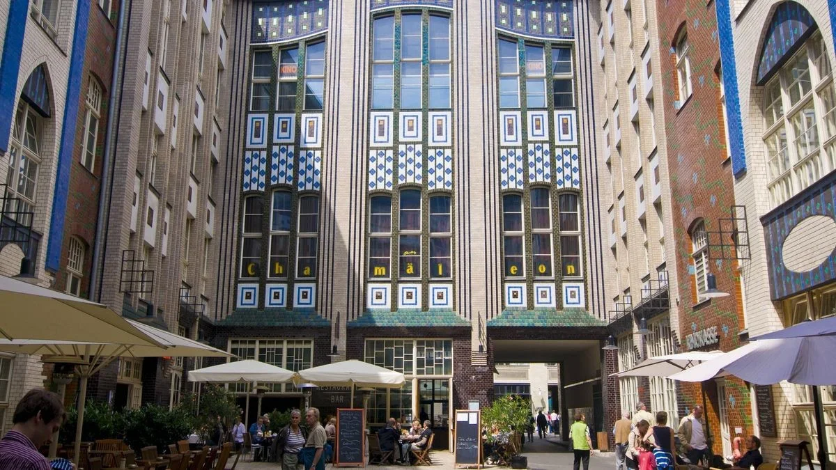 Hackesche Höfe: cafe tables beneath the courtyard's patterned tile facade