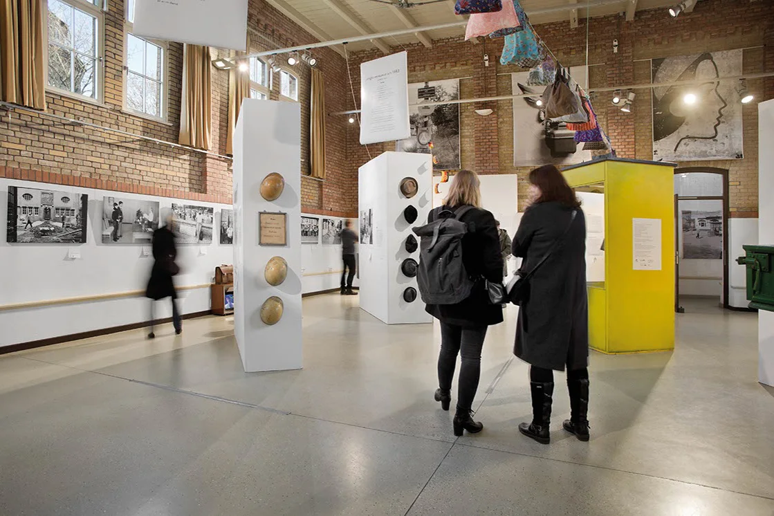 Visitors among historical objects and photographs at Museum Pankow Prenzlauer Allee