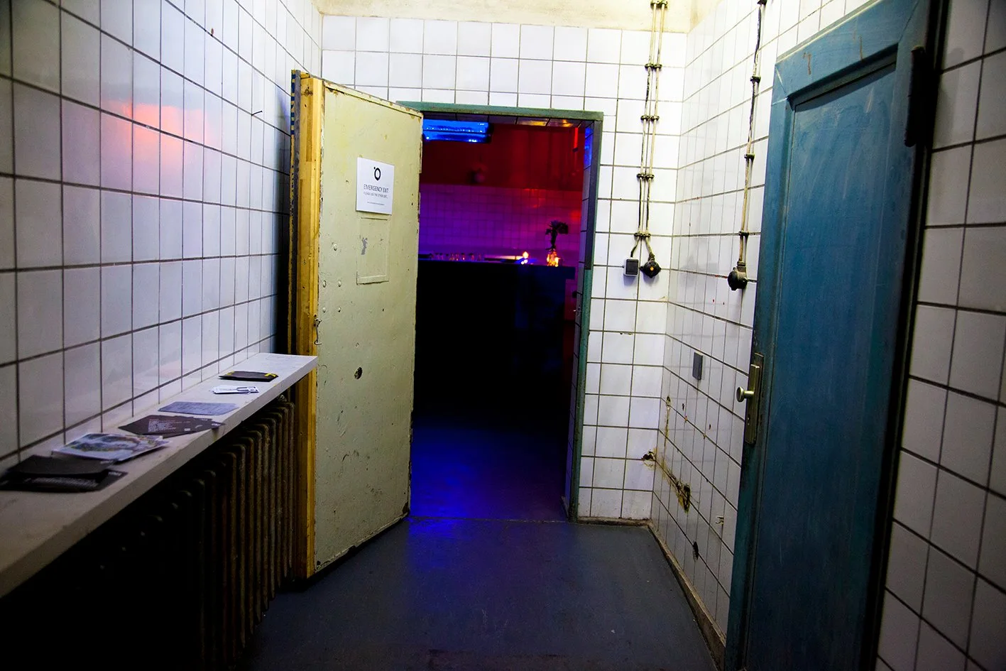 OHM: the tiled industrial entrance opening onto the club's purple-lit room