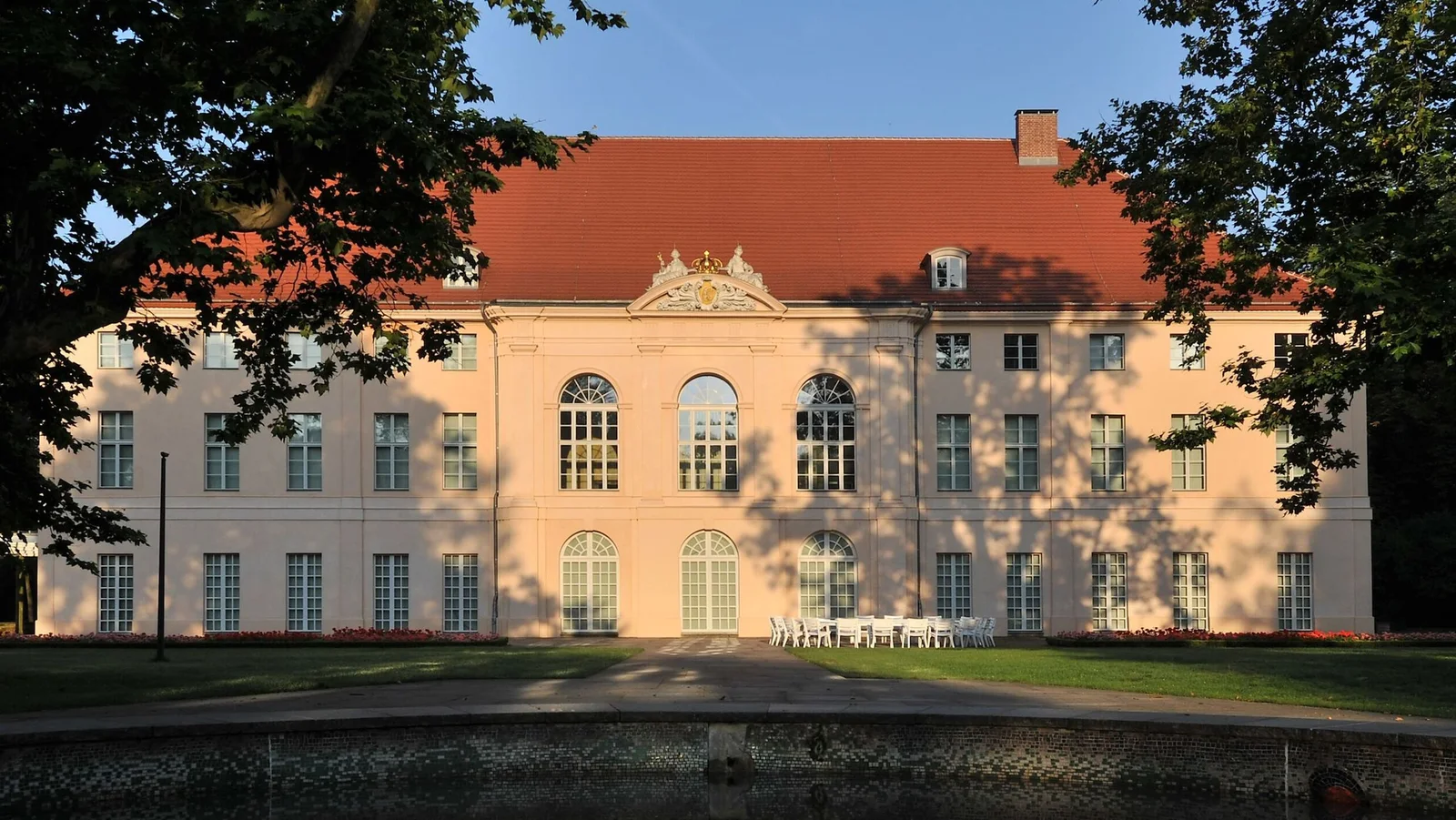 The palace facade framed by trees at Schloss Schönhausen