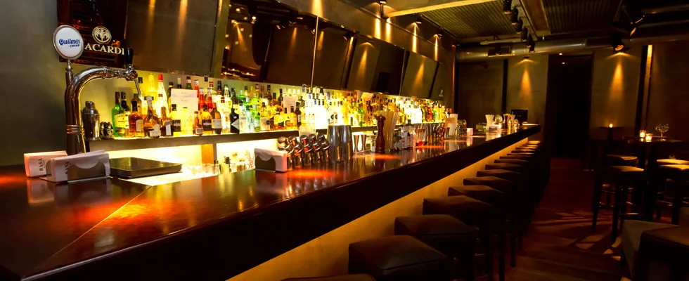 An amber-lit counter running the length of the bar at BASA