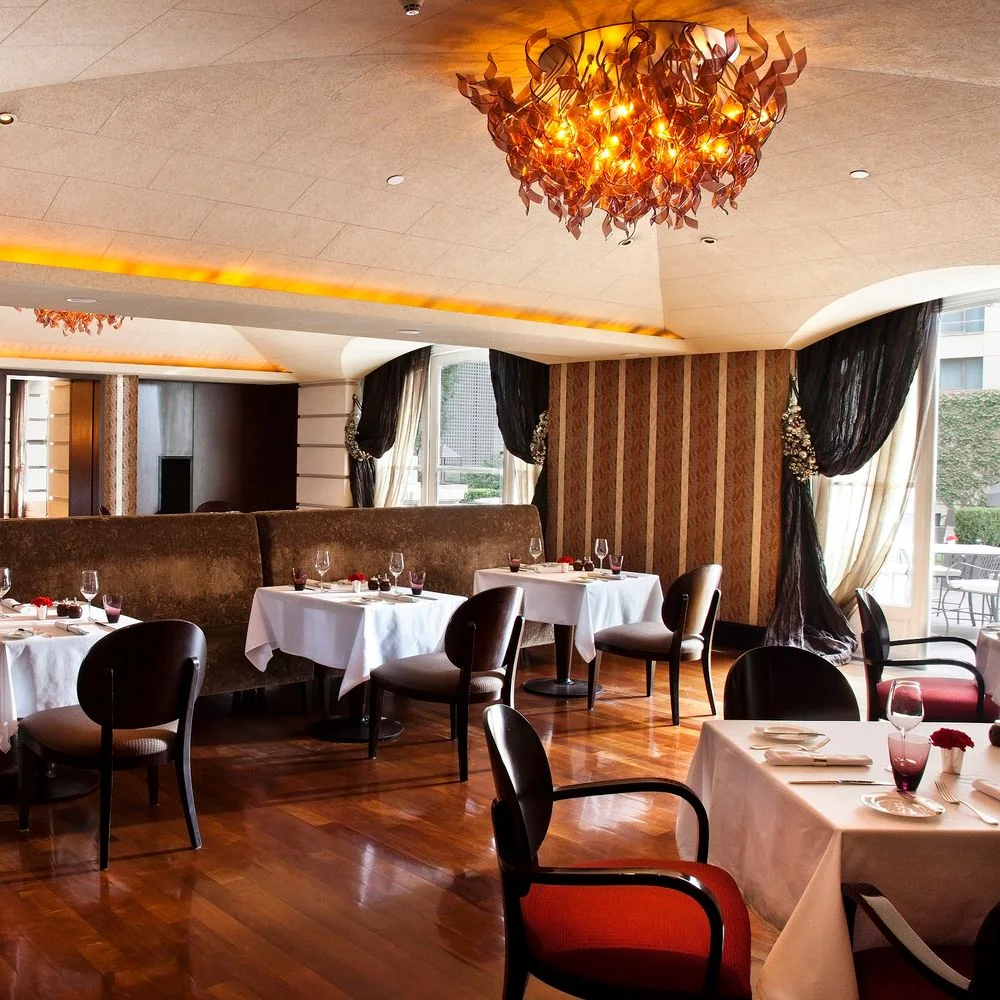 Duhau Restaurante & Vinoteca: elegant dining room with chandelier and set tables