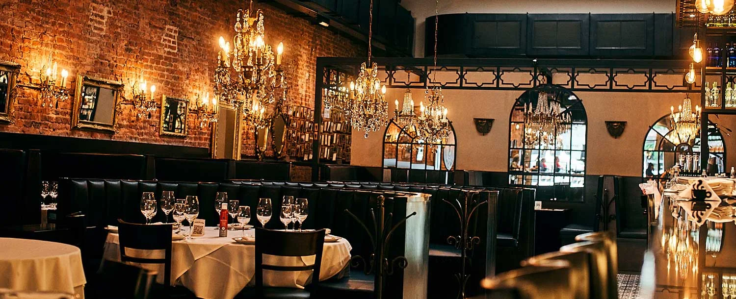 Mirrors and chandeliers above the restaurant tables at El Tropezón
