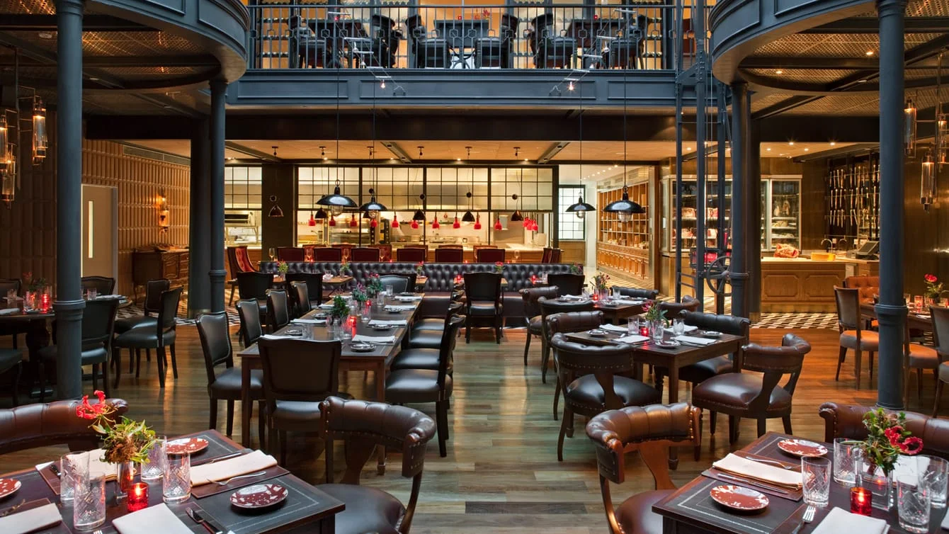 The double-height dining room and central counter at Elena