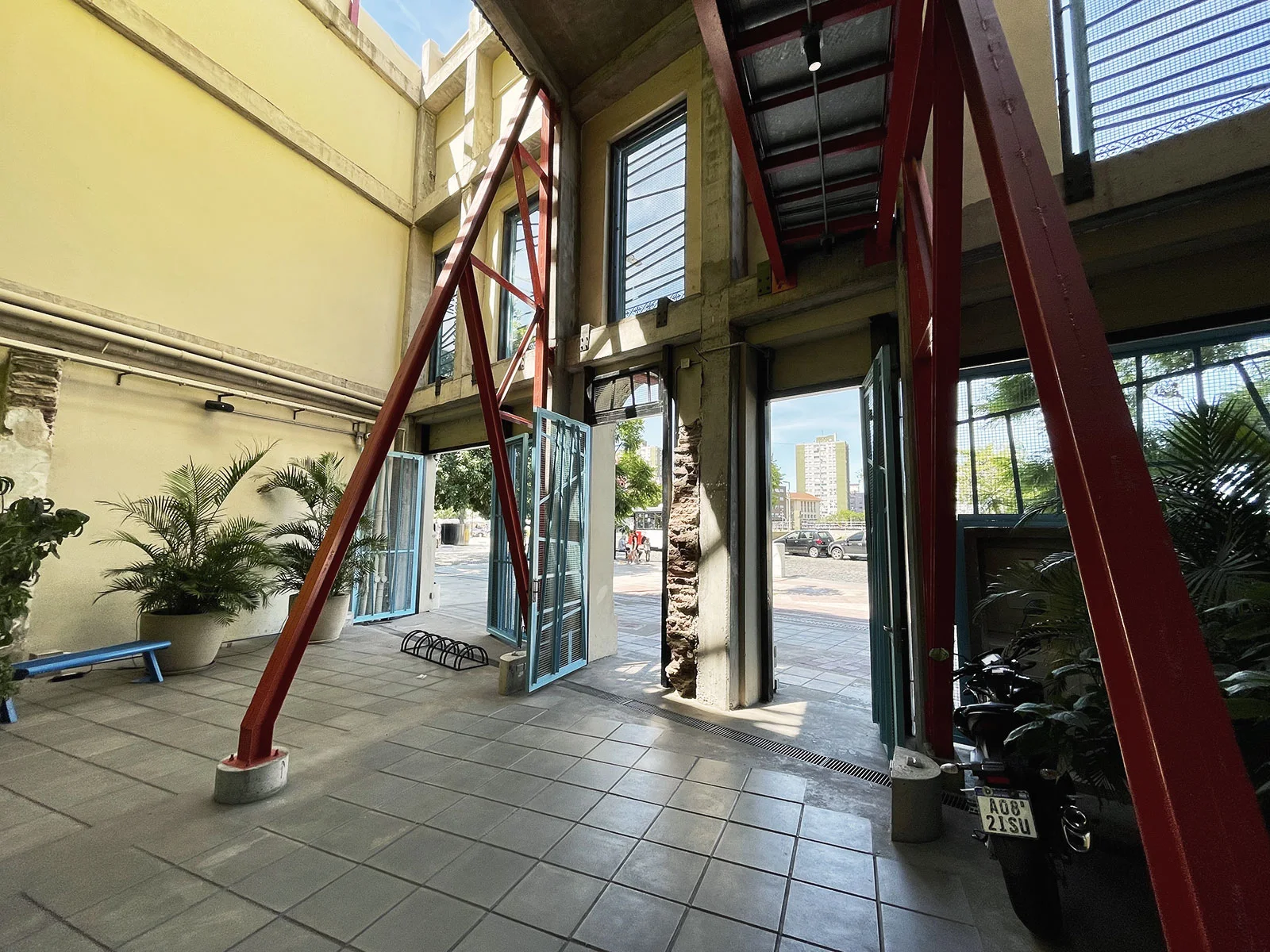 Fundación Andreani: exposed red structural beams around the foundation's bright entrance courtyard