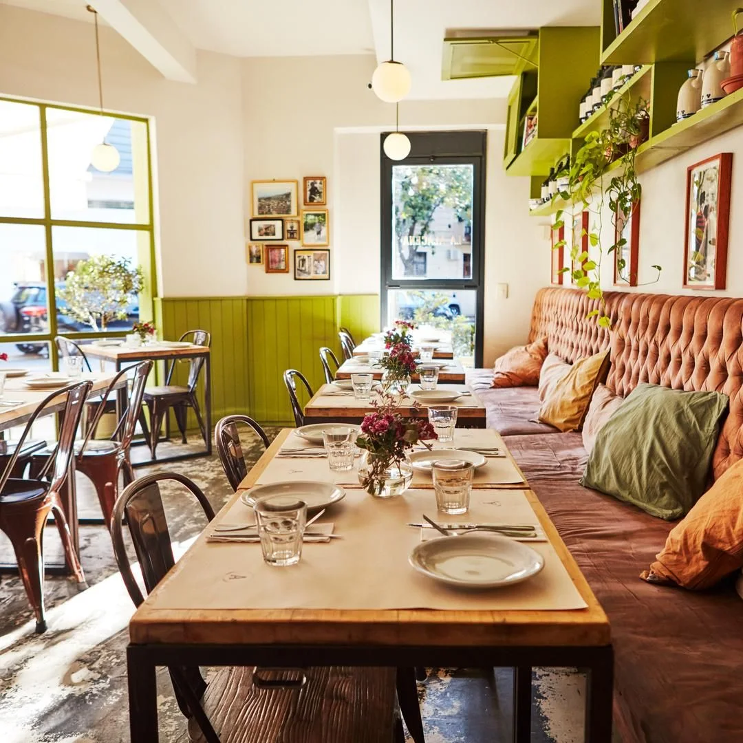 La Alacena Trattoria: dining room with green walls and set tables
