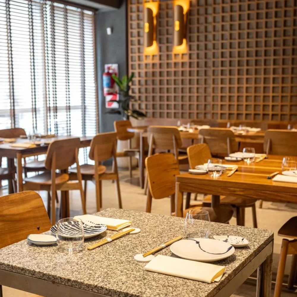 Nika Club Omakase: wooden dining tables and latticed wall