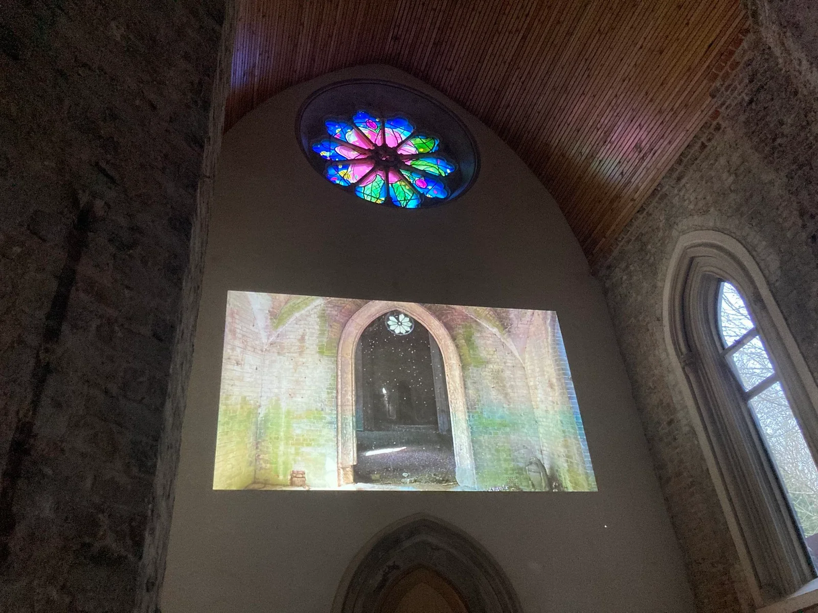 The chapel interior and stained-glass rose window at Abney Park