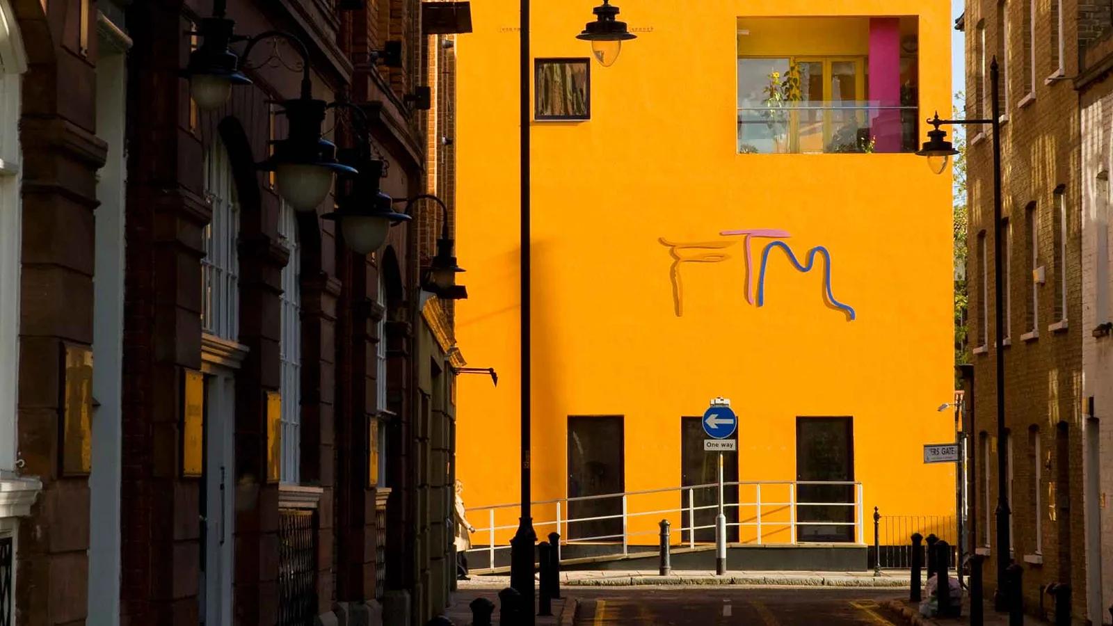 The museum's vivid orange street facade at Fashion and Textile Museum