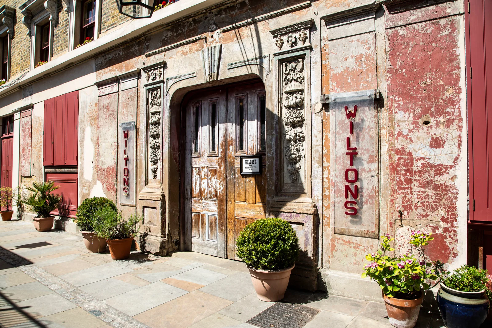 The historic weathered facade and music hall entrance at Wilton’s Music Hall