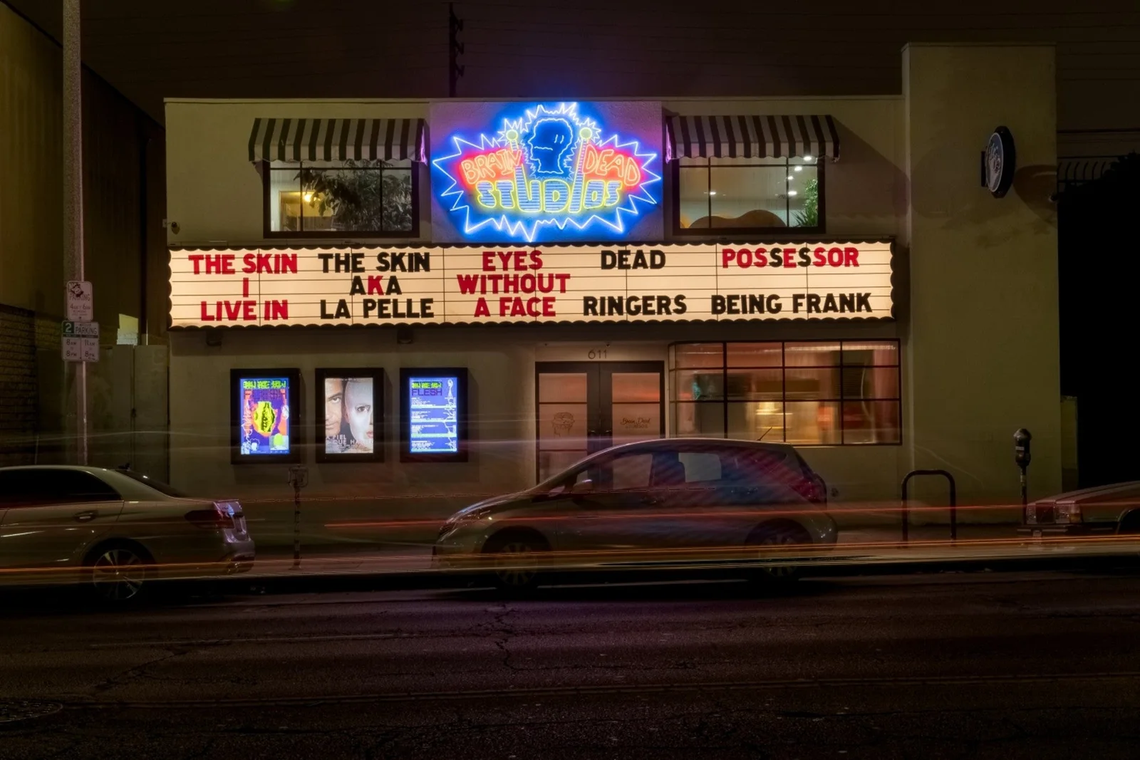 The cinema facade and illuminated marquee at Brain Dead Studios
