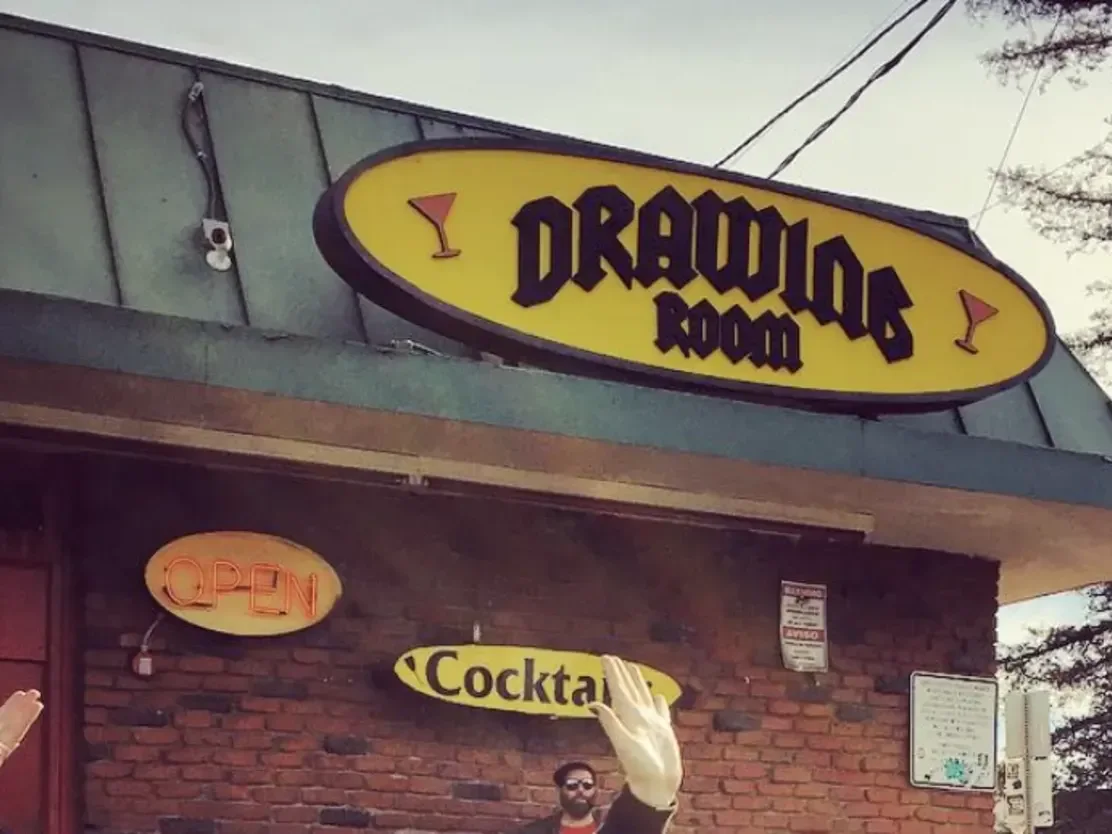 The bar’s exterior sign and entrance at Drawing Room