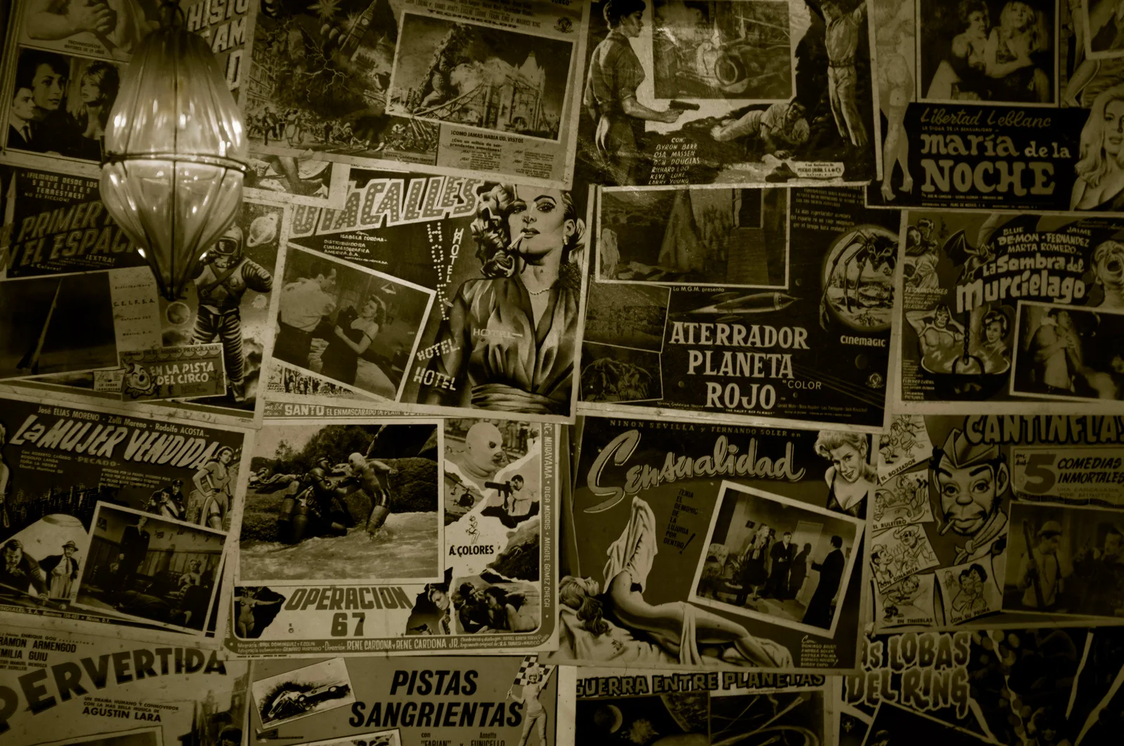 El Carmen: vintage Mexican film posters and a wall lamp forming part of the bar's decor