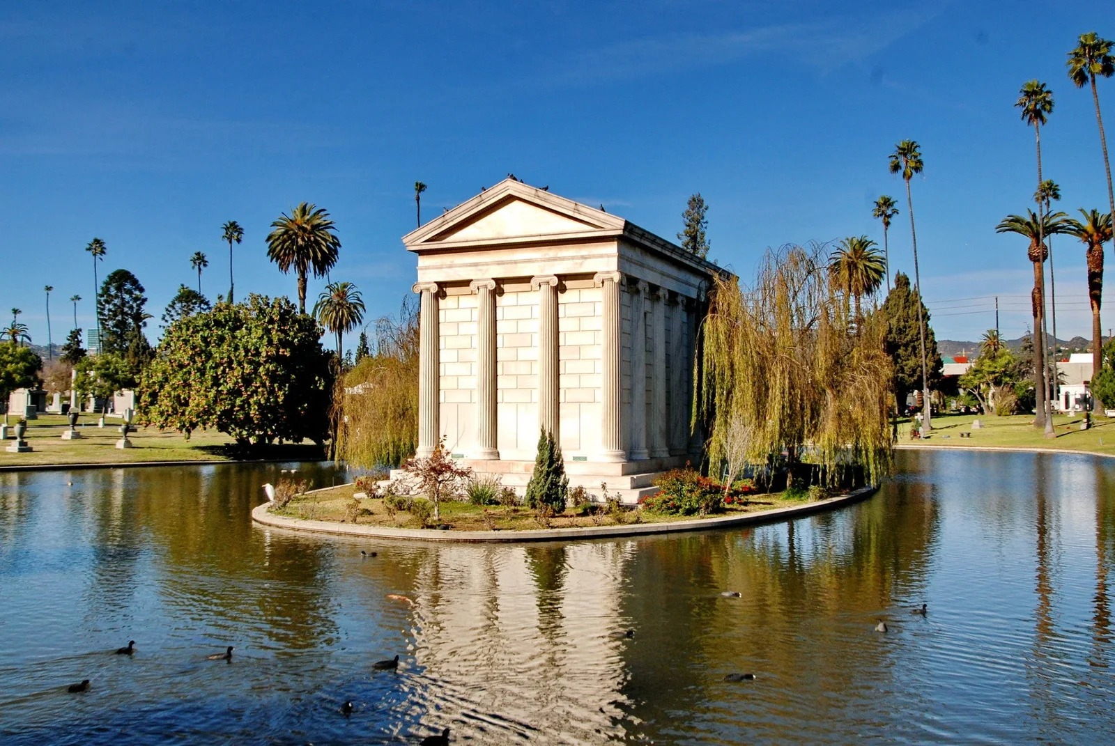 The lakeside mausoleum and palm-lined cemetery grounds at Hollywood Forever Cemetery