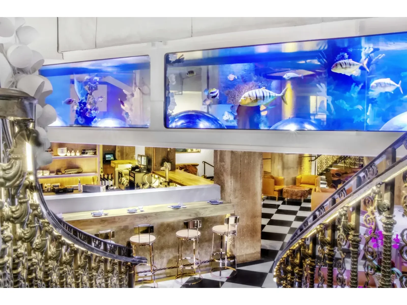 The staircase, dining room and illuminated fish tank at Mrs. Fish