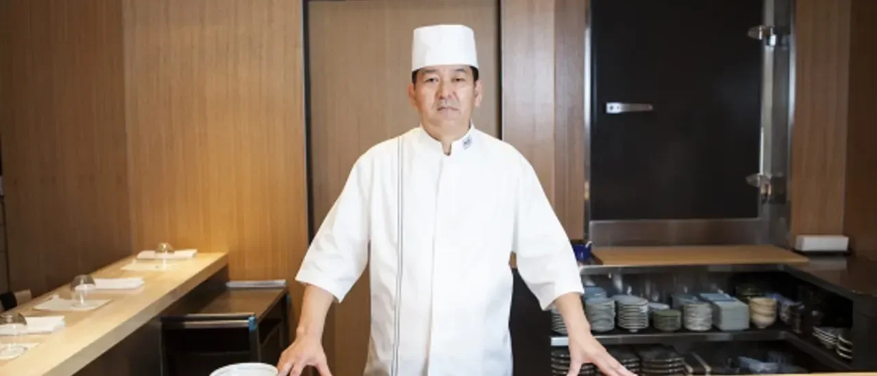 Chef Fujita at the restaurant's wooden sushi counter at Nozawa Bar