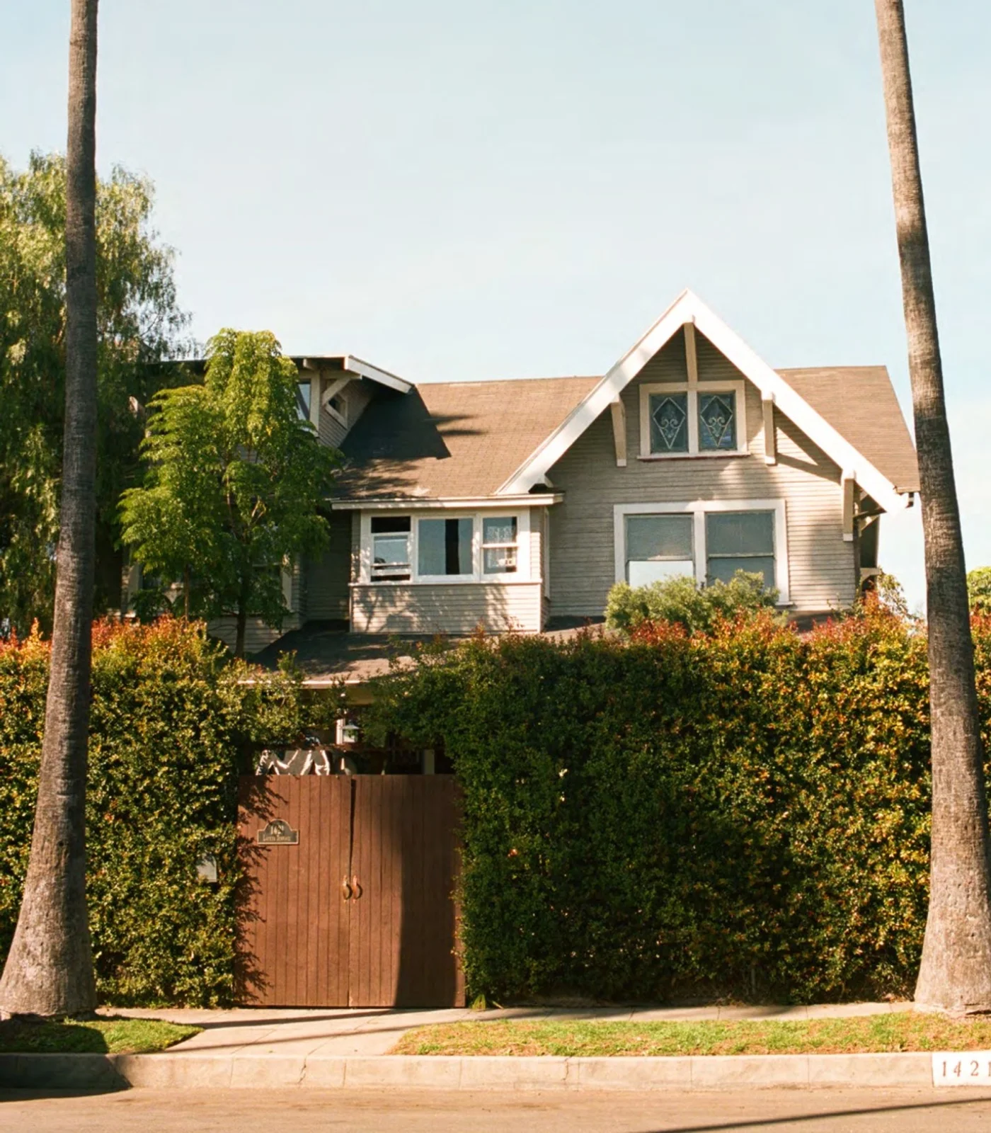 The historic house above a hedge-lined street at Tom of Finland Foundation House