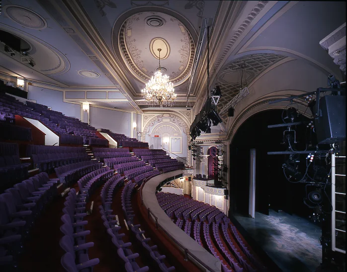 An ornate theatre auditorium seen from the side balcony at Ambassador Theatre