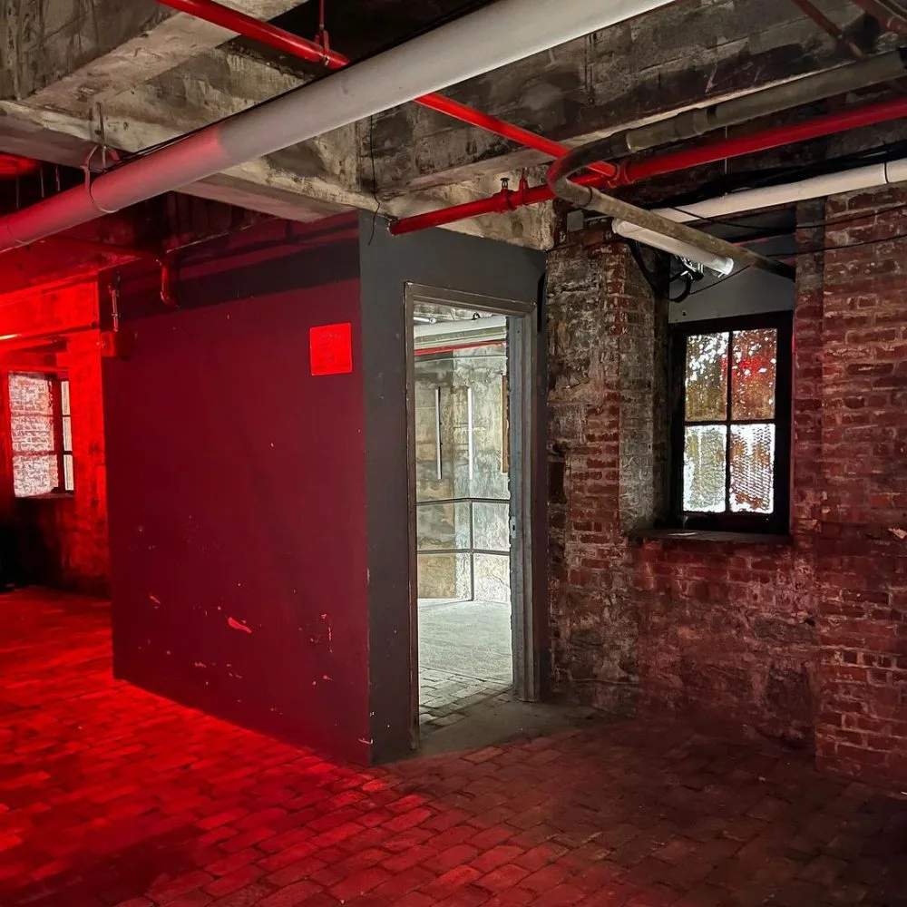 Red light and exposed brick inside STUDIO at BASEMENT, New York