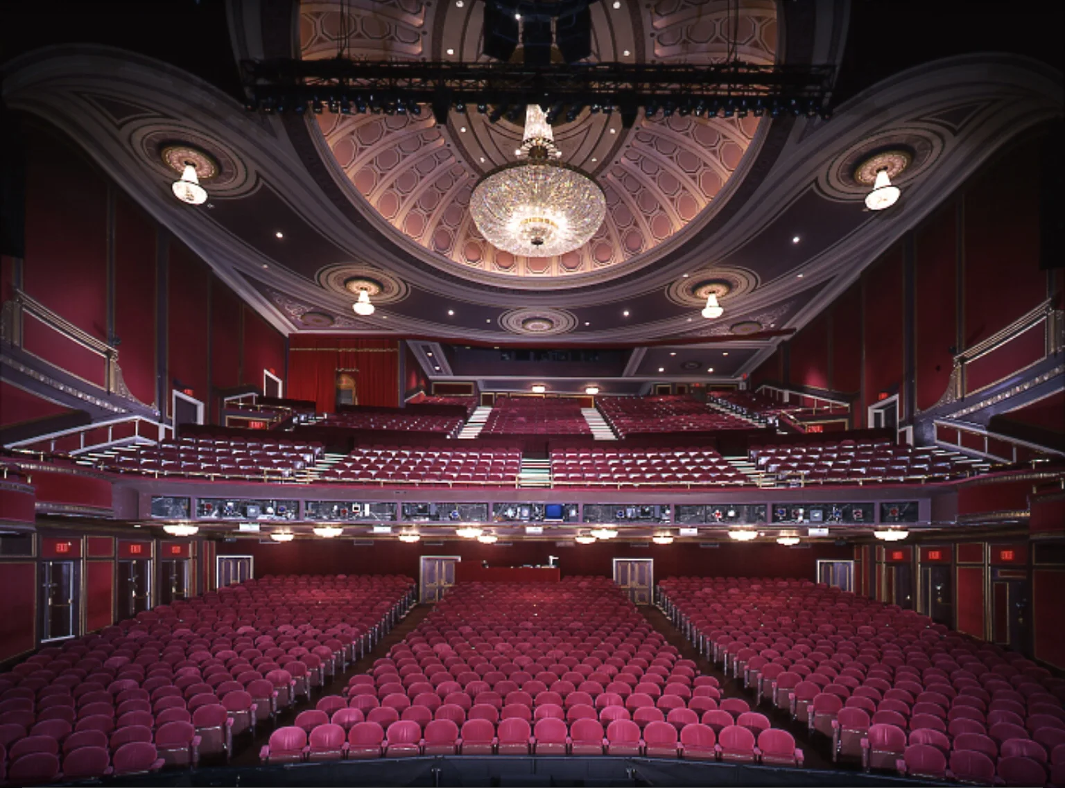 Broadway Theatre: auditorium viewed from the stage, with crimson seating, a large chandelier and an ornate ceiling