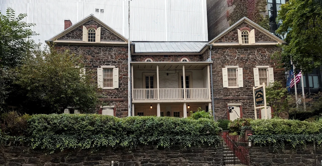 The historic stone building and garden at Mount Vernon Hotel Museum & Garden