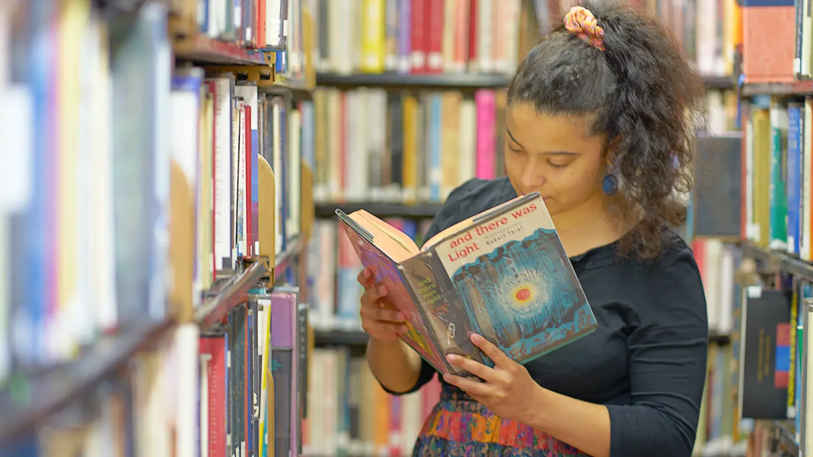 A young reader among the library shelves at New York Society Library