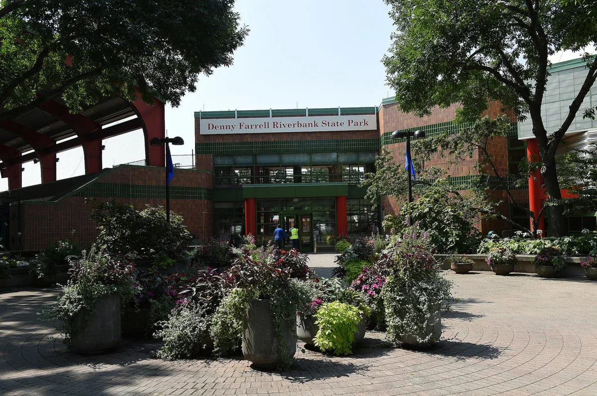 Denny Farrell Riverbank State Park: the park entrance framed by trees and landscaped flowerbeds