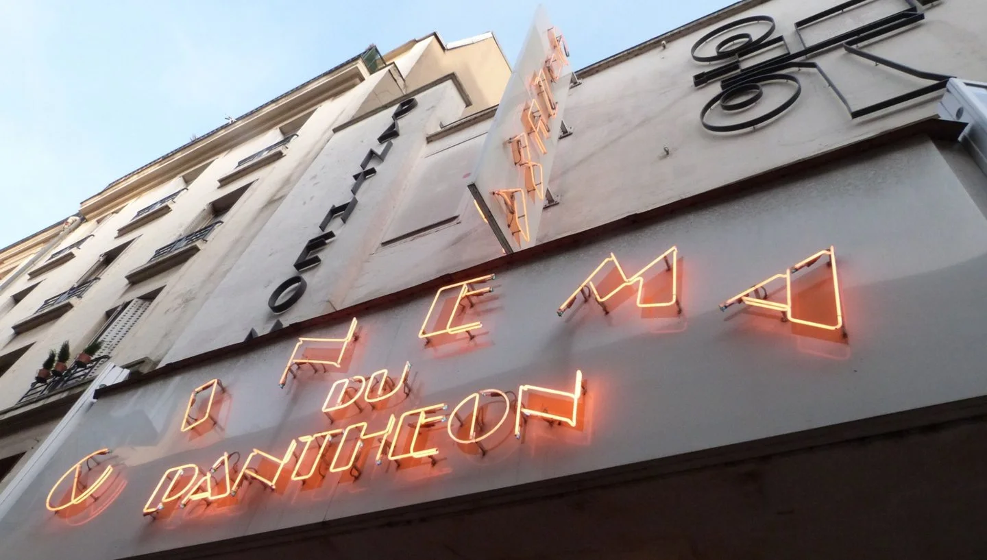 Neon cinema lettering on the street facade at Cinéma du Panthéon