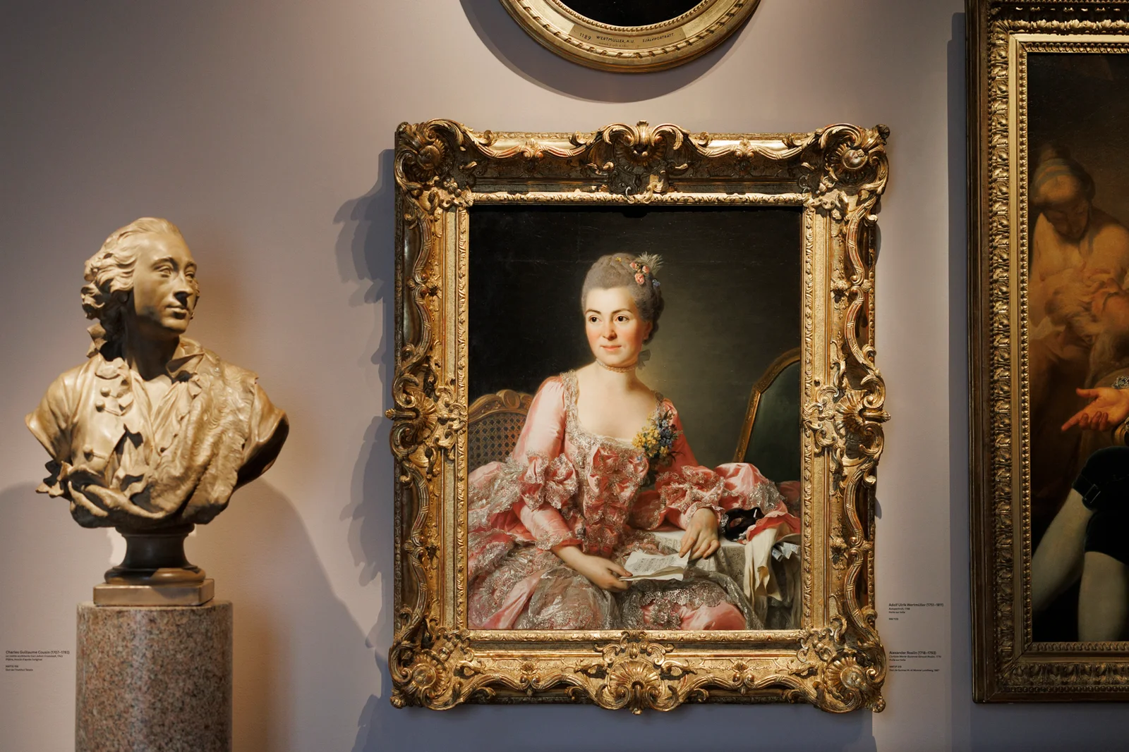A sculpture and framed portrait in the collection at Institut suédois