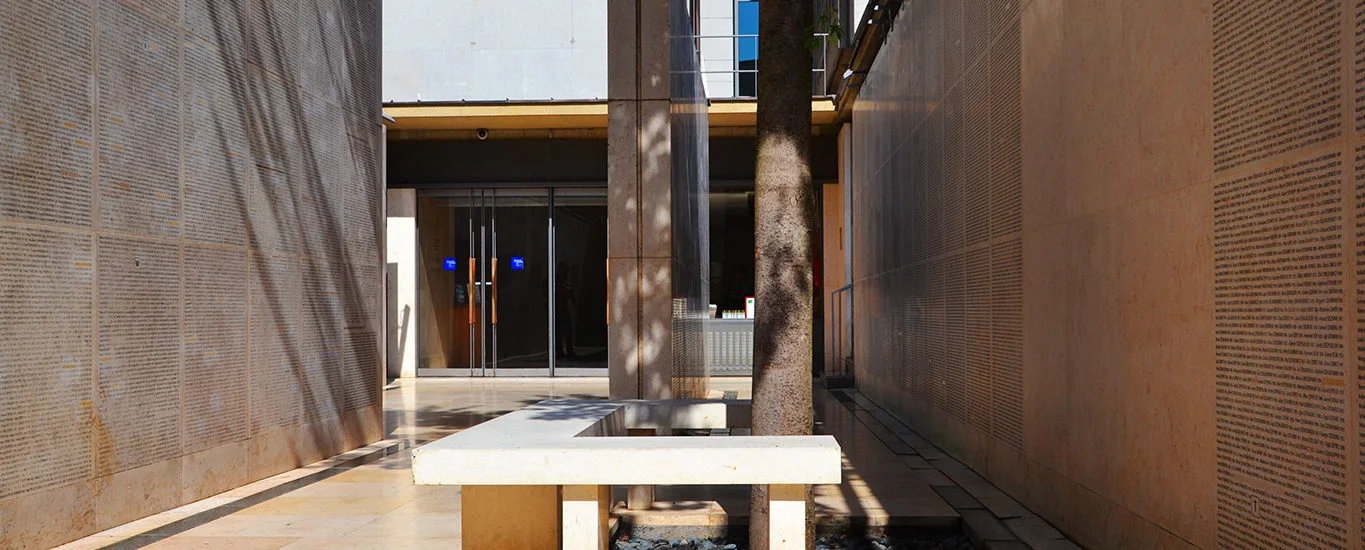 A quiet stone memorial space with a central structure at Mémorial de la Shoah