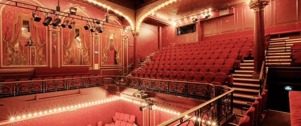 Ornate red balconies and seats inside the theatre at Théâtre de l’Œuvre