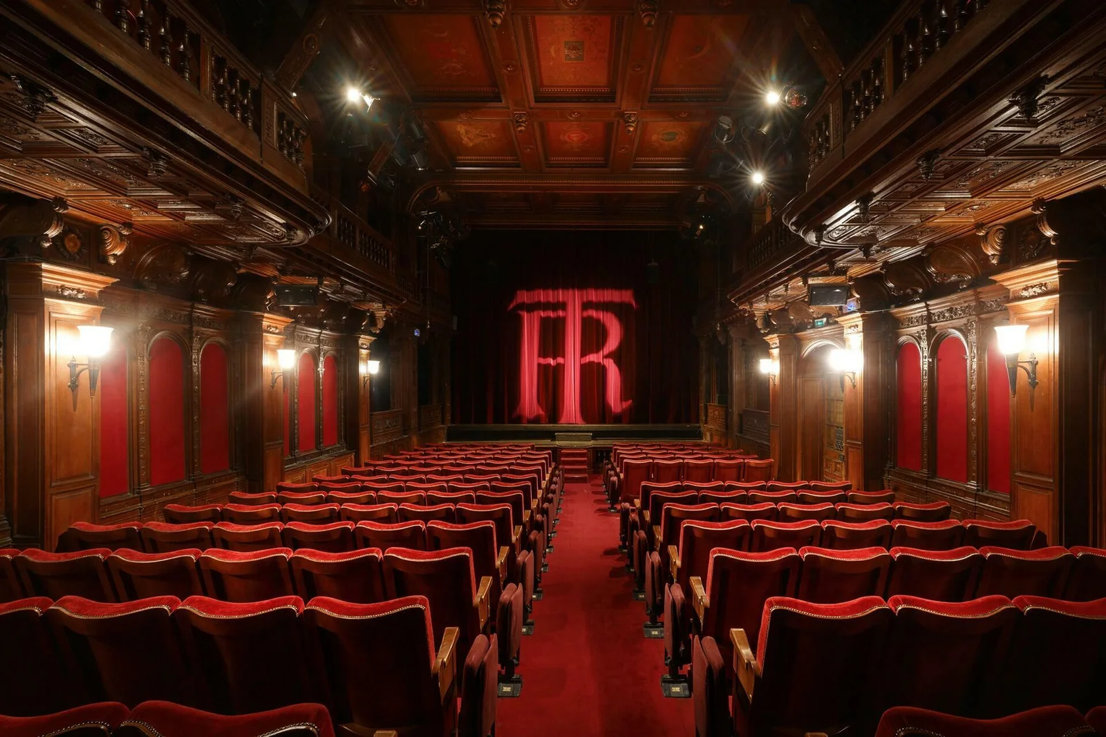 Red seats beneath the theatre's carved timber ceiling at Théâtre Le Ranelagh