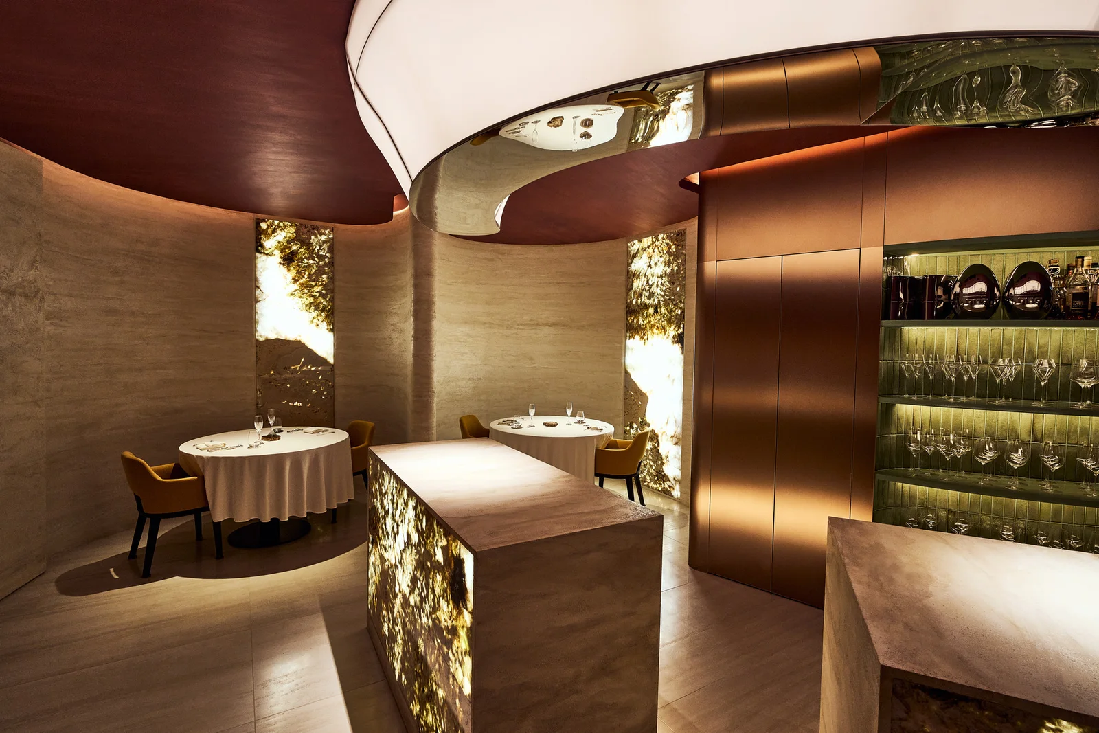 Curved walls, warm lighting and neatly set tables at KANG MINCHUL Restaurant