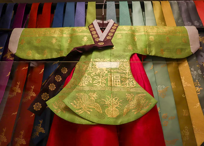 A traditional garment decorated with gold-leaf patterns at Kum Bak Yeon