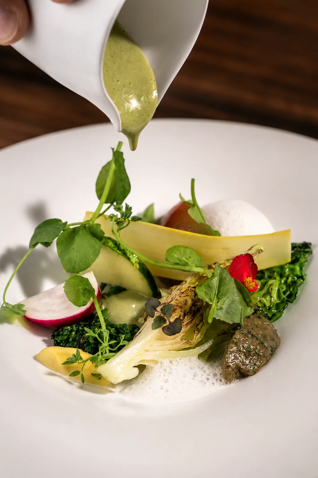 Sonnet: a sauce being poured over a plated salad, shown on its official website